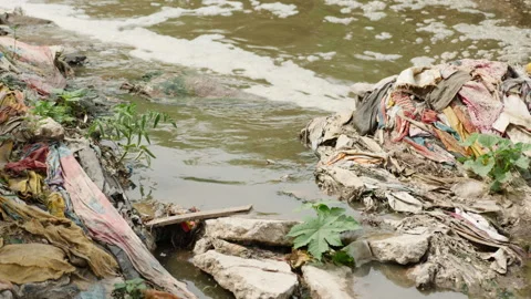 River that is polluted with various garbage and trash Stock Footage 139052884