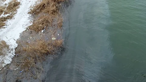 River pollutet with oil. A layer of oil on water in 4k resolution Stock Footage 80759626