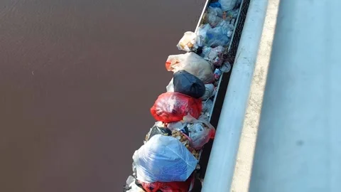 River Pollution by Plastic Waste on Bojonegoro Bridge Pillars 4K Vídeos de archivo 318866219