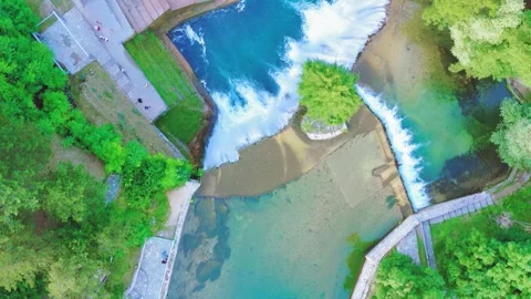 River pools and pedestrian bridge in waterfall park, Bosnia and Herzegovina, Stock Footage 326200560