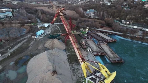 River-port loading area with rail-mounted portal cranes in a drone aerial view. Stock Footage 345369732