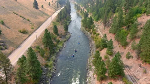 River rafting trip down a mountain river as a is drone flying up and over head. Vídeo Stock 159753125