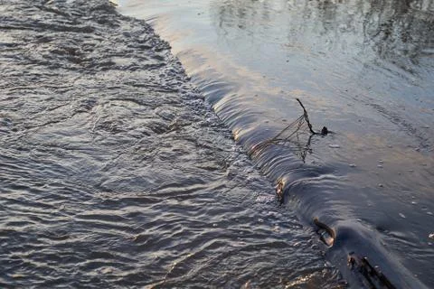 River with a rapid flow in the spring at sunset Stock Photos