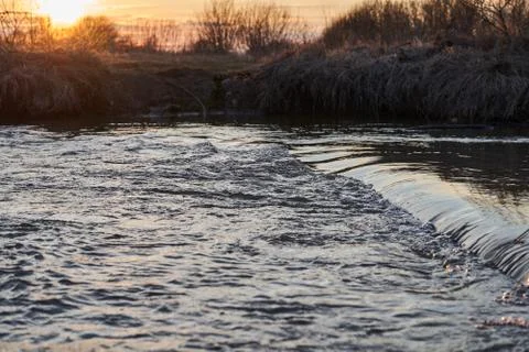 River with a rapid flow in the spring at sunset Stock Photos