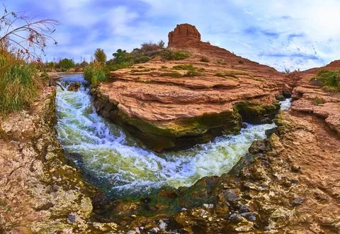 River Rapids and Red Rock Butte Under Dramatic Sky Panoramic Landscape Stock Photos