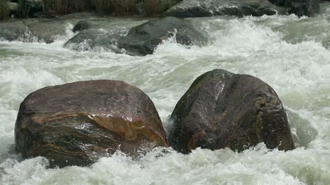 River rapids flowing around boulder, Lamjung District, Nepal Stock Footage 139689459