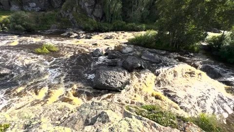 A river with rapids flows rapidly between the mountains Stock Footage 285148670
