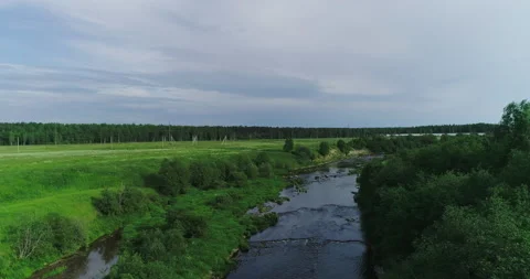 River with rapids surrounded by green meadows and forests Stock Footage 156285224