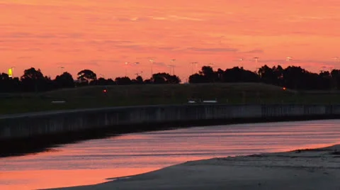 River Reflecting Pink Sunset next to airport 160GYAP 0018 PAL Stock Footage 26540315