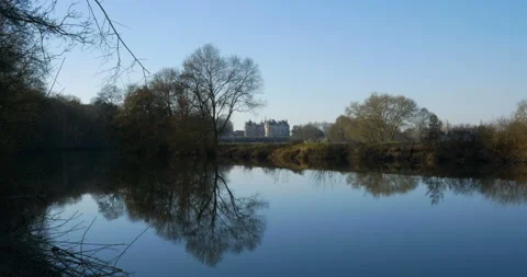 River reflecting trees and castle, beautiful nature scenery. clear blue sky Stock Footage 103841763