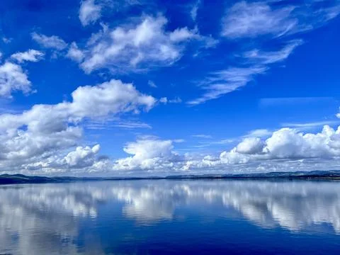 River Reflection - clouds reflecting in the river. Stock Photos