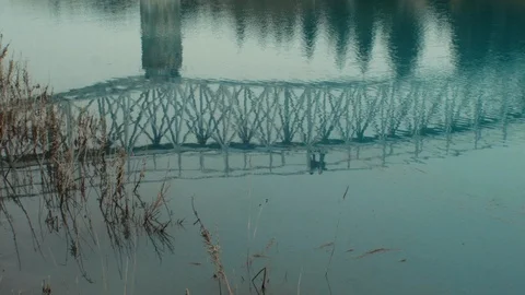 River reflection of a couple running along the bridge Stock Footage 100020826