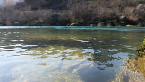 River with reflection of sunlight and stones under water Stock Footage 104663028
