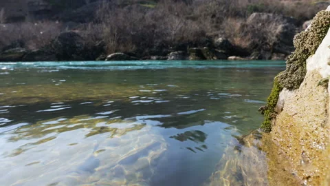River with reflection of sunlight and stones under water 库存影片 104664269