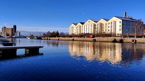 River Reflections of Waterfront Hotel Stock Footage 99219535