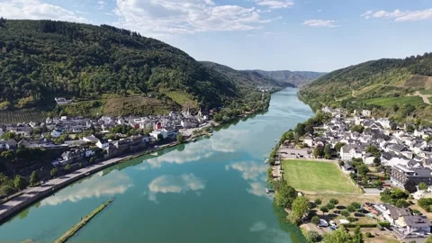 A river reflects clouds between hillside settlements in Germany 動画素材 342336446