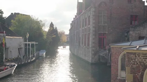River reveal with reflections next to church in Bruges Belgium Stock-Footage 329053435