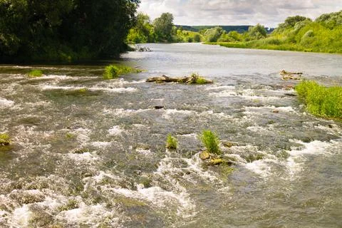 River rift, splashes of water in the river shimmering in different colors Stock Photos