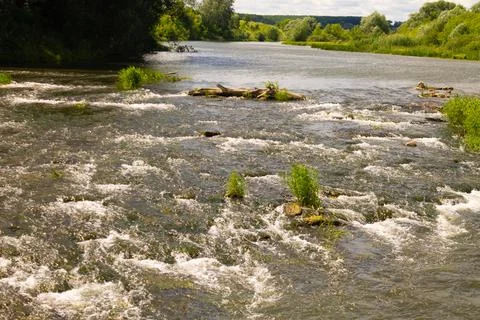 River rift, splashes of water in the river shimmering in different colors Stock Photos