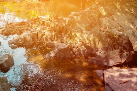 River in rock with jungle sunrays Stock Photos