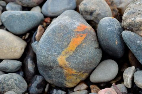 River rock with orange stripe Stock Photos