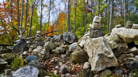River rocks balanced on top of each other in a natural setting in autumn Stock Photos