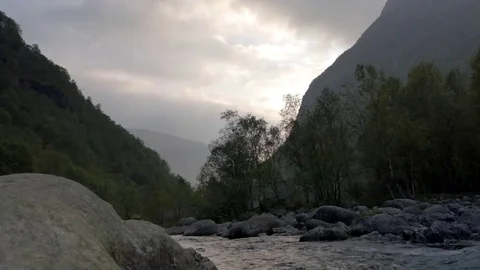 River running downhill in a valley Stock Footage 73292494