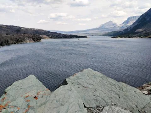 River Running Next To A Mountain. Stock Photos