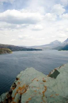 River Running Next To A Mountain. Stock Photos