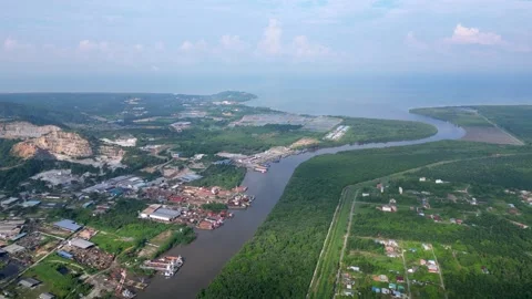 A river runs through a town with houses and buildings. Aerial Batu Pahat Video stock 325831734