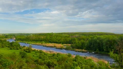 River rushing through stony canyon among green prairies time lapse scene Vídeos de archivo 246803937