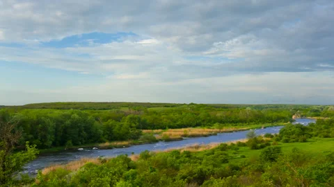 River rushing through stony canyon among green prairies Vídeos de archivo 313280915
