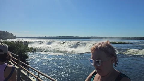 River Rushing Toward Waterfall Edge From Walkway, Iguazu, Argentina 8K Video stock 306472376