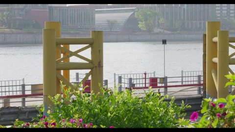 River Scene with Dock and Moving Barge, Urban Waterfront View Stock Footage 330948388