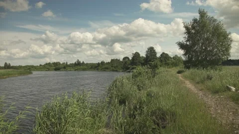 River scene in flatlands in a windy day and a foot path next to it Stock-Footage 161152796