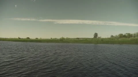 River scene with meadows in the opposite side in a windy sunny day Stock Footage 161152654