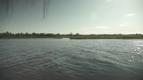 River scene with meadows in the opposite side in a windy sunny day Stock Footage 161153028