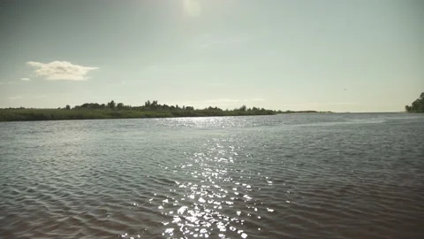 River scene with meadows in the opposite side in a windy sunny day Stock Footage 161153102