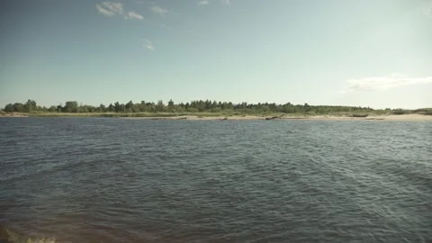 River scene with meadows in the opposite side in a windy sunny day Stock Footage 161153293