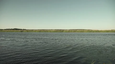 River scene with meadows in the opposite side in a windy sunny evening Stock-Footage 161153442