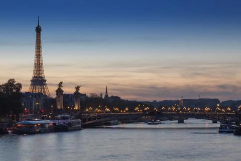 The River Seine surrounded by buildings with the Eiffel Tower during the even Fotos Stock