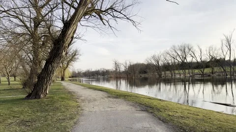 River Sidewalk with Trees Sunset 4K HDR Stock Footage 250368040