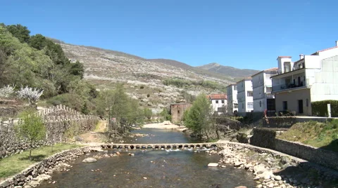River with a small crossing between village and cherry plantations Stock Footage 49556051