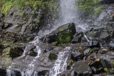 River with small waterfall and many rocks Stock Photos