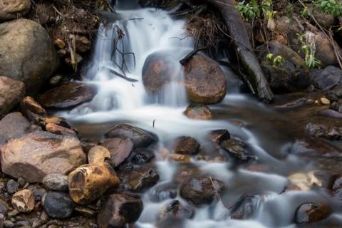 River with small waterfall and many rocks Stock Photos