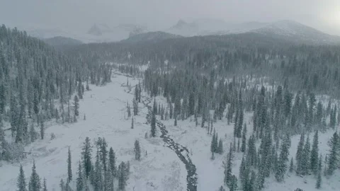 River in snow forest and mountains, Ergaki, Siberia, Russia Stock Footage 141829401