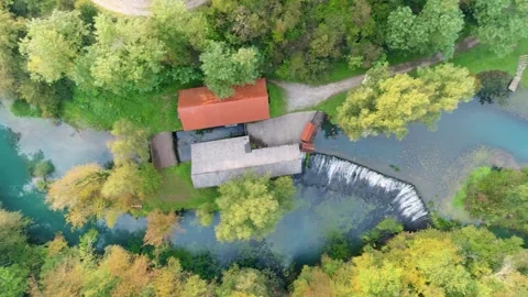 River source and buildings in autumn colors aerial view Stock Footage 327072001