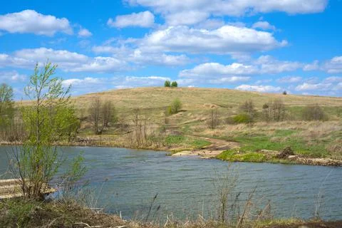 The river in spring and the grass is still sand-colored. Stock-Fotos