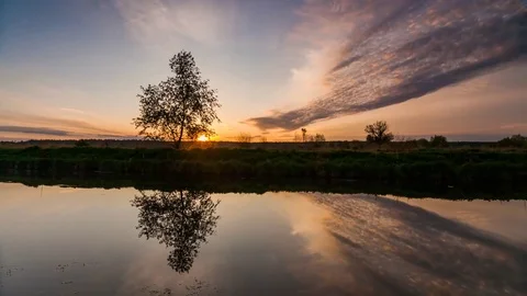 River in spring at dawn. Reflection of clouds in water Stock Footage 75847122