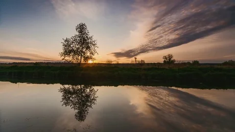 River in spring at dawn. Reflection of clouds in water Stock Footage 75847713